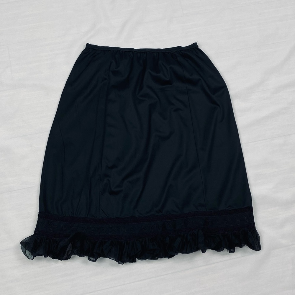 Vintage Adonna medium black half slip scalloped lace trimmed hem.